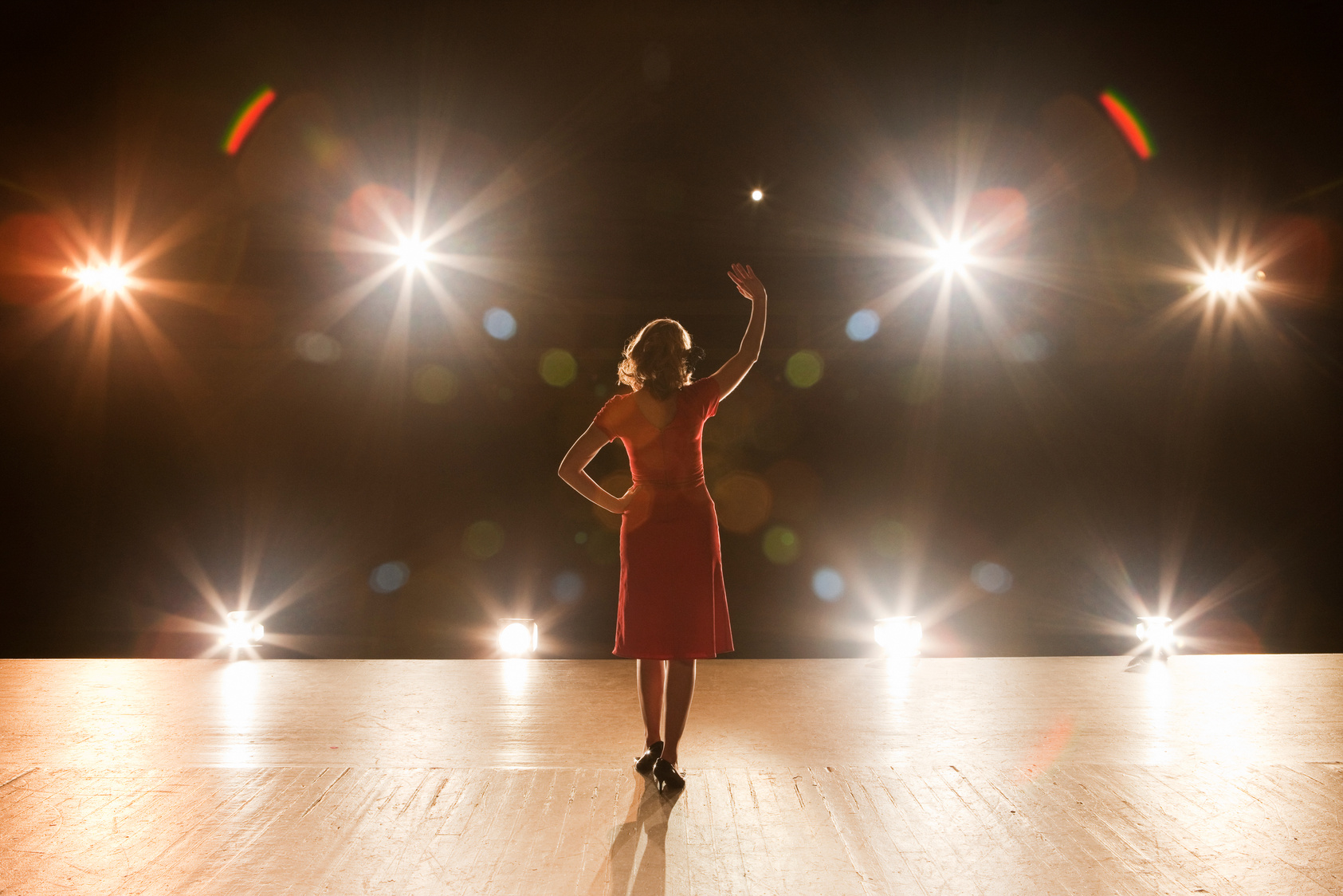 Live Performer Standing on Stage with Lights